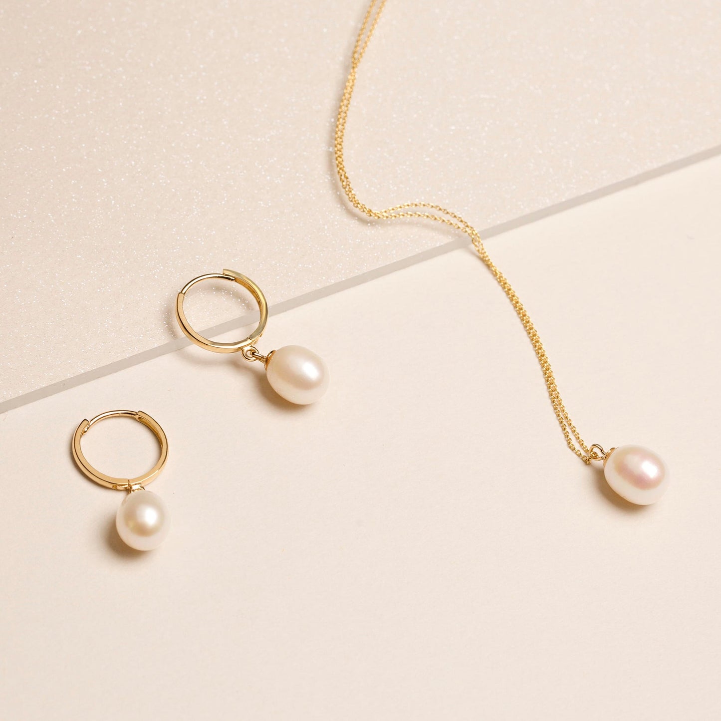 Elegant Elliptical Pearl Huggie Earrings