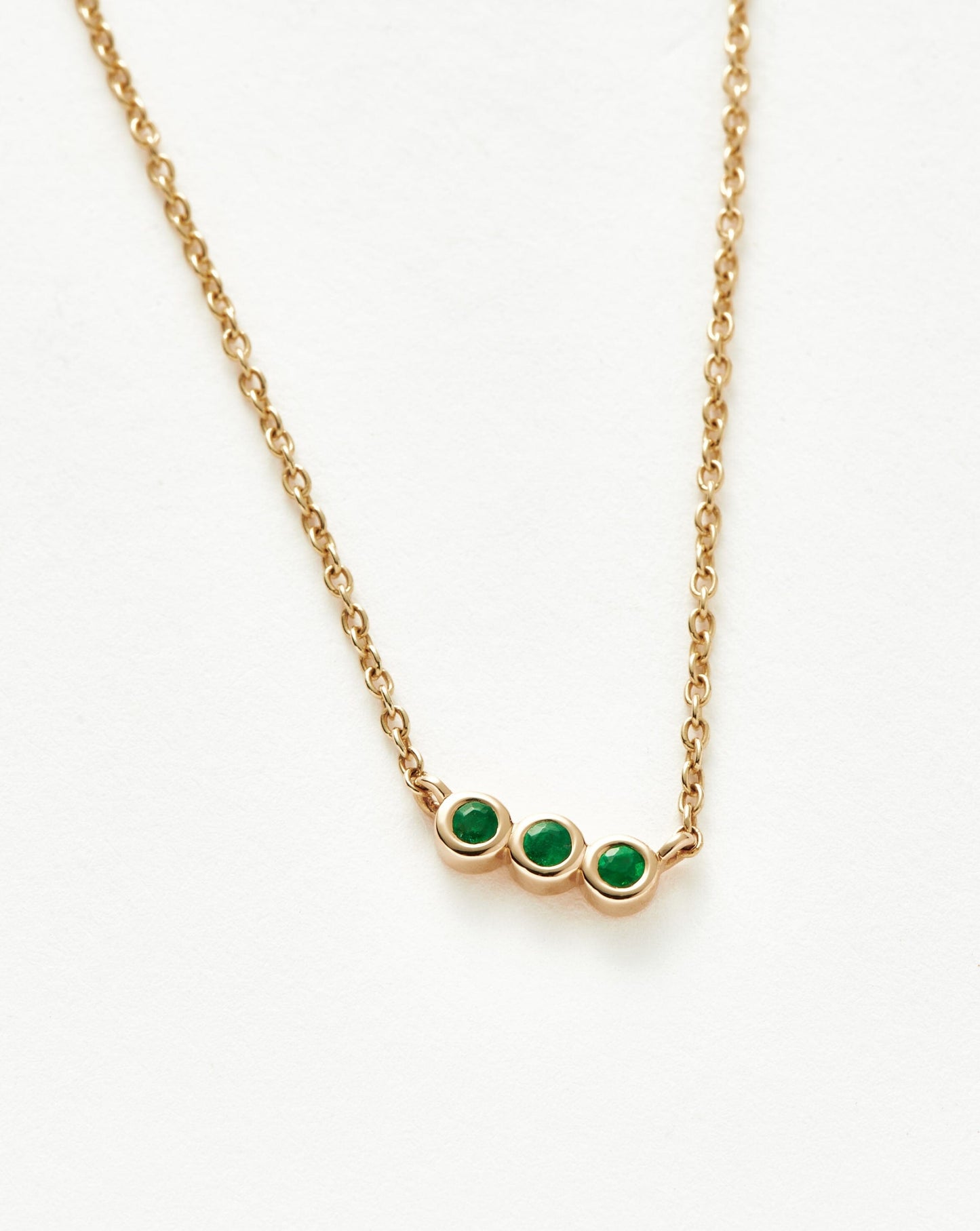 Emerald Solitaire Trio Necklace in Fine Design